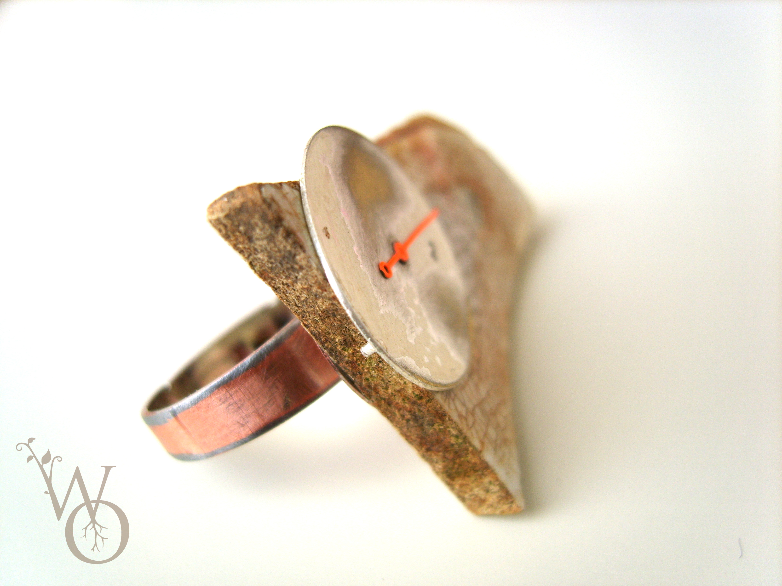side view of ring with clock parts and aged ceramics