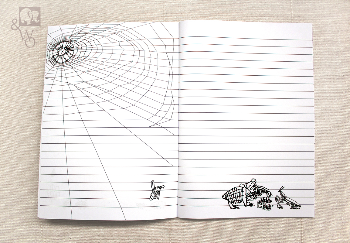 an illustrated black and white lined A6 notebook