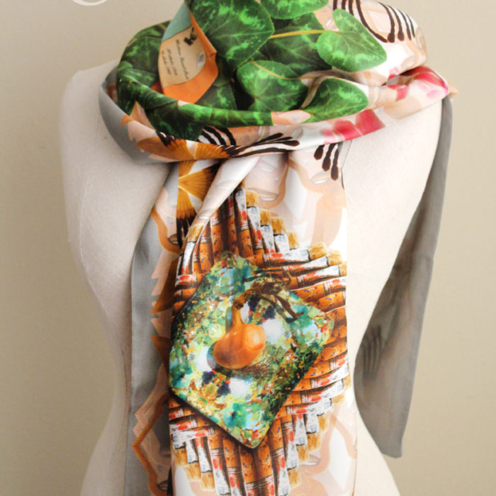 scarf with a colourful photorealistic print of various objects.